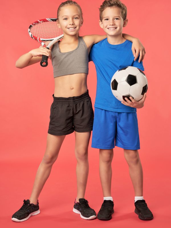 Adorable sporty kids standing against red background top cbse school in greater noida west